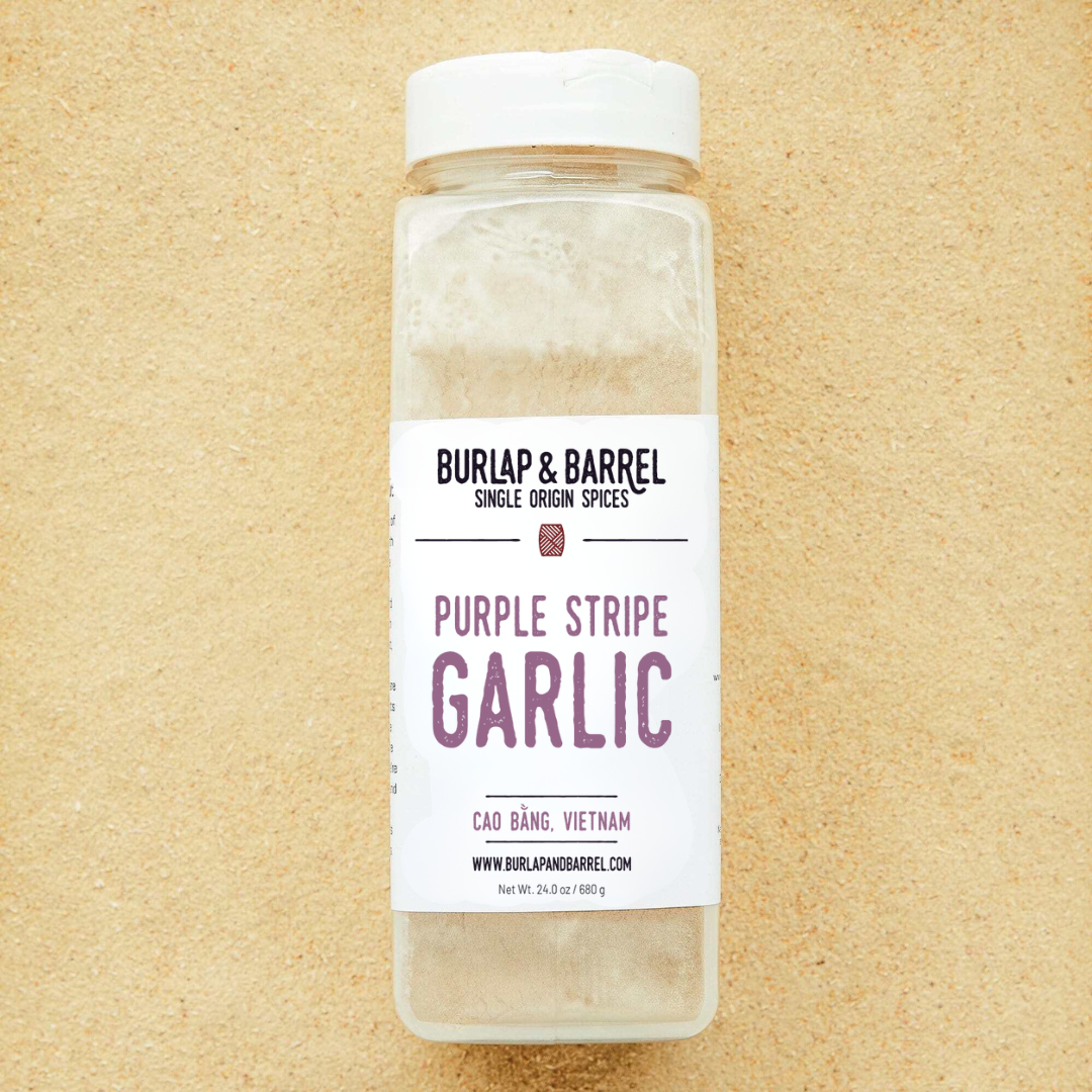 Bottle of Burlap & Barrel Purple Stripe Garlic on a beige background