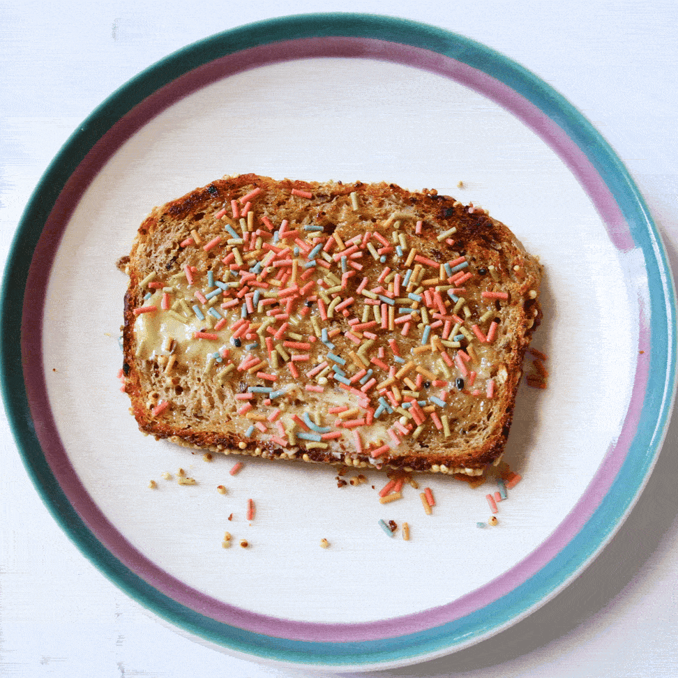 Gif of toast with spiced sprinkles with bites being take out of it until it is gone on a white plate