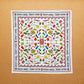 A multicolored, 100% cotton bandana with hand-drawn spice illustrations laid out flat on a surface.