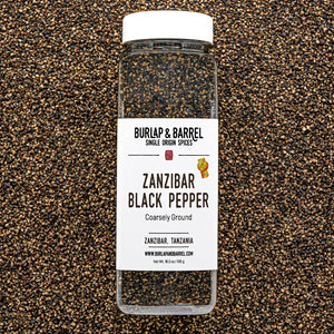 Bottle of Burlap & Barrel Zanzibar Black Pepper on a textured black and brown background