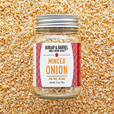 Jar of minced onion spice with 'Burlap & Barrel' label on a textured background