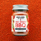 Jar of Burlap & Barrel Sweet Mesquite BBQ spice blend on a red background