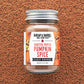 Jar of Burlap & Barrel Toasted Pepita Pumpkin Spice on a brown textured background