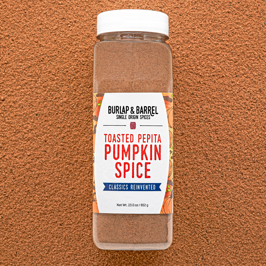 Container of Burlap & Barrel Toasted Pepita Pumpkin Spice on a brown background