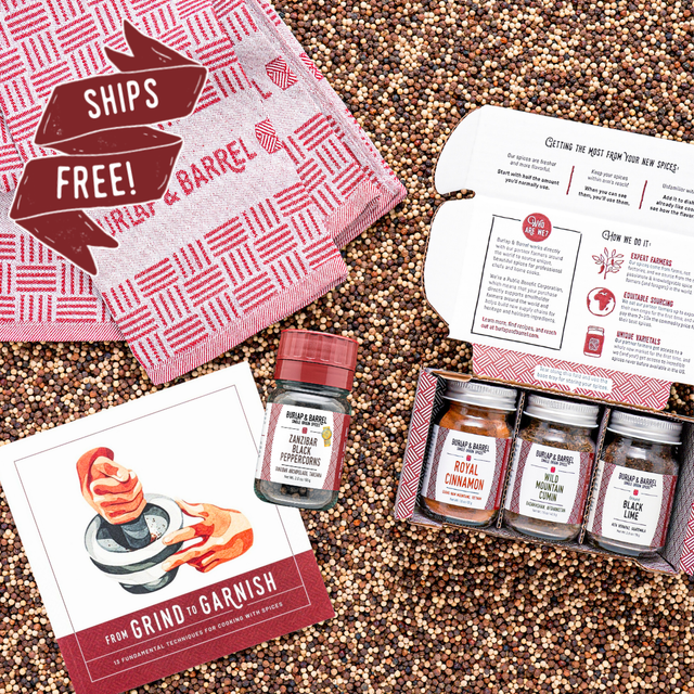 Spice set with jars, a recipe book, and a towel on a textured surface